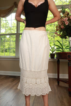 Load image into Gallery viewer, White crochet lace hem midi skirt by Elektra Vintage, showcasing intricate knit pattern and flowing fabric design.
