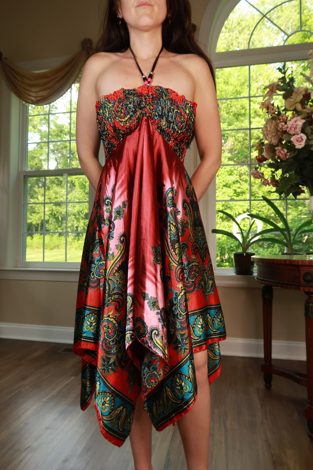 Vintage Elektra Vintage silk paisley halter dress with handkerchief hem, featuring a flowing, feminine silhouette and intricate pattern.