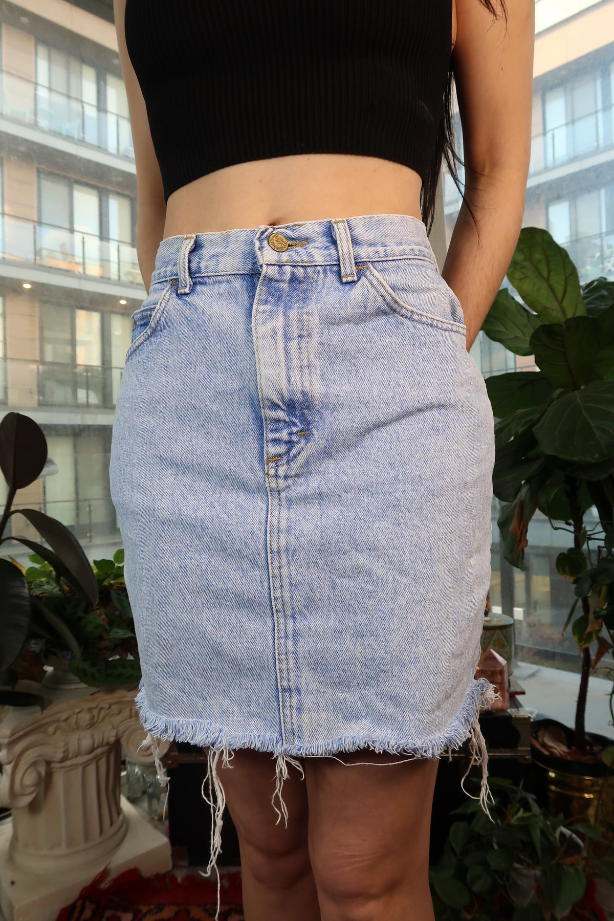 Vintage 90s Lee light wash denim mini skirt from Elektra Vintage, showing front view with classic denim texture and stitching.