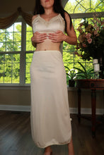 Load image into Gallery viewer, Vintage ivory satin maxi slip skirt from Elektra Vintage, featuring a flowing design and elegant satin fabric.
