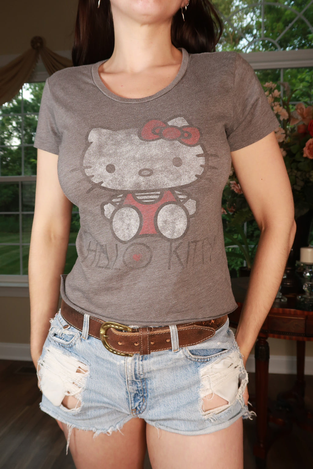 Vintage Hello Kitty graphic baby tee for women by Elektra Vintage, featuring a cute Hello Kitty design on a casual top.