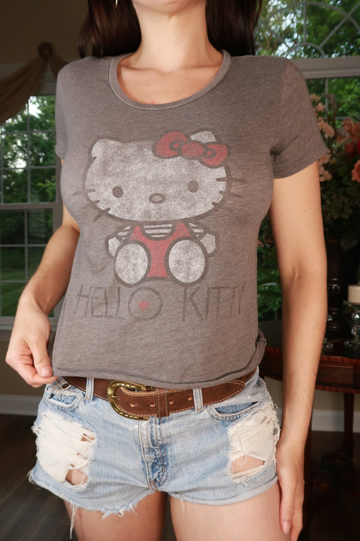 Vintage Hello Kitty graphic baby tee for women by Elektra Vintage, featuring a cute Hello Kitty design on a casual top.