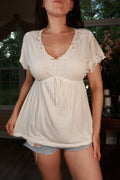 White embroidered Y2K vintage babydoll peasant top for women by Elektra Vintage, featuring intricate embroidery and flowy fabric.