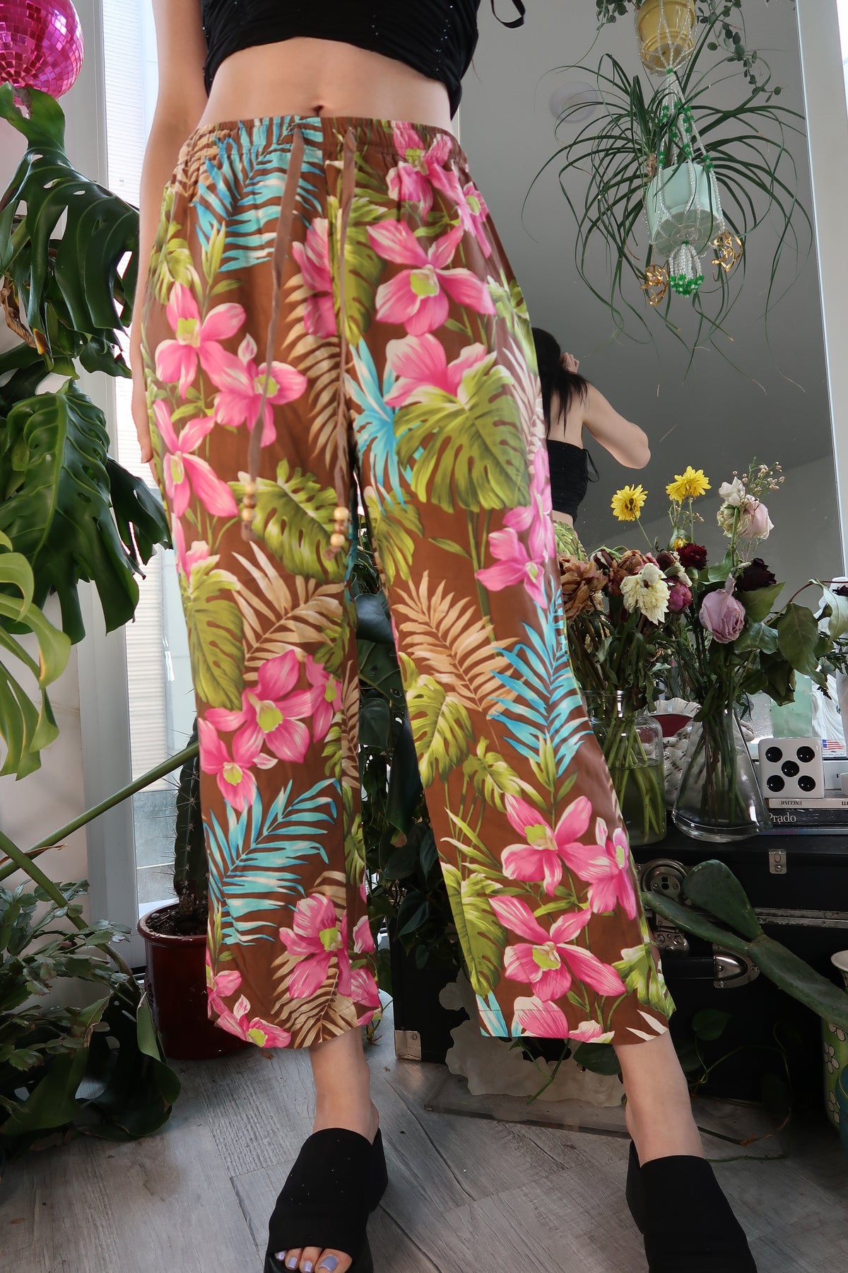 Women's vintage silk cropped trousers with tropical pattern and drawstring waist by Elektra Vintage, featuring vibrant floral details.