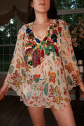Vintage Elektra Women's Y2K floral sequin bell sleeve tunic top, embellished with colorful floral patterns and playful bell sleeves.