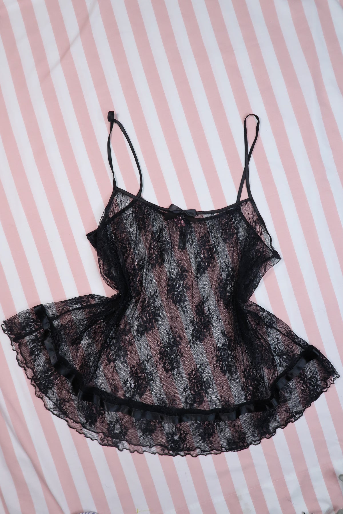 Vintage 2000s Victoria’s Secret black lace babydoll camisole top for women, featuring sheer fabric and delicate lace details.