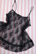 Vintage 2000s Victoria’s Secret black lace babydoll camisole top for women, featuring sheer fabric and delicate lace details.