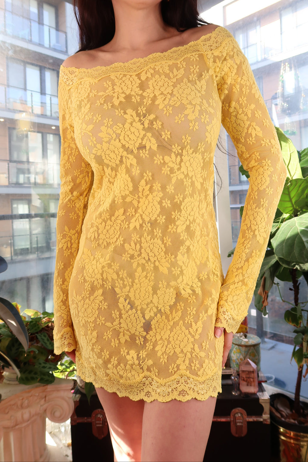Yellow lace off-shoulder dress by Elektra Vintage displayed on a mannequin with a soft background.