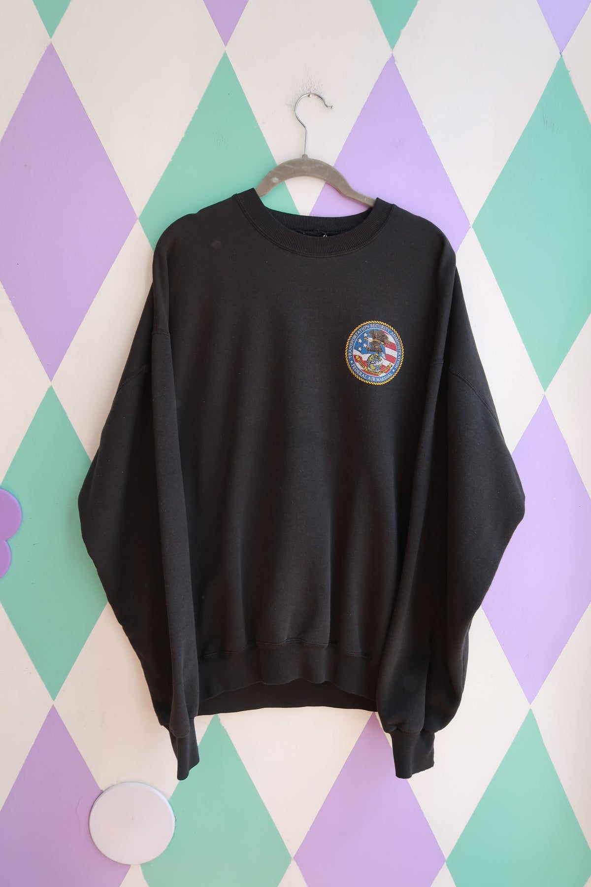 Elektra Vintage men's black crewneck sweatshirt featuring Transportation Security Administration Federal Air Marshal logo.
