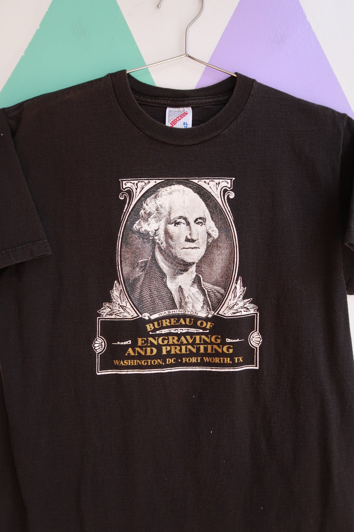 Men's vintage black graphic T-shirt featuring George Washington design by Elektra Vintage, with a classic Bureau of Engraving and Printing theme.