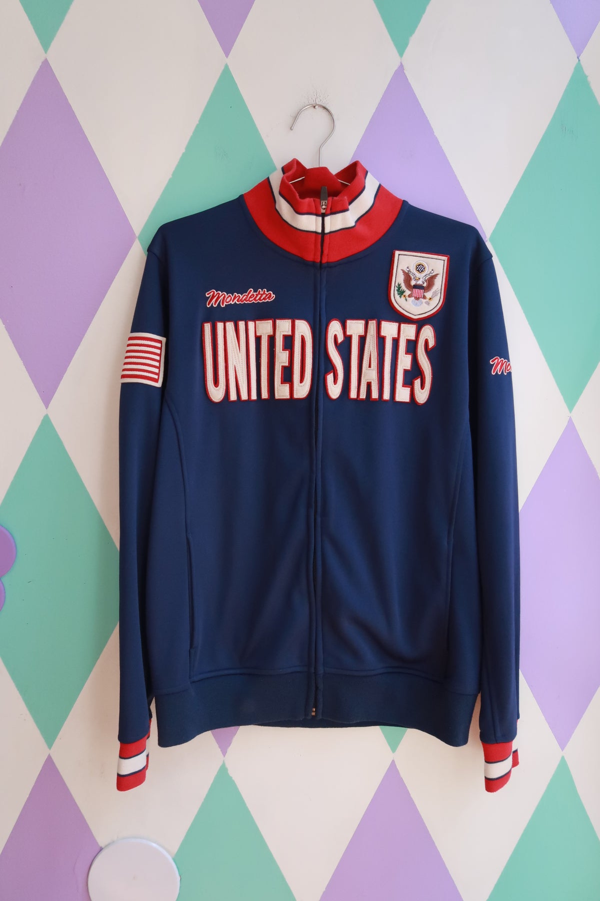 Vintage Elektra Vintage Mondetta U.S. Team full zip track jacket with USA flag and sporty design, front view in image.