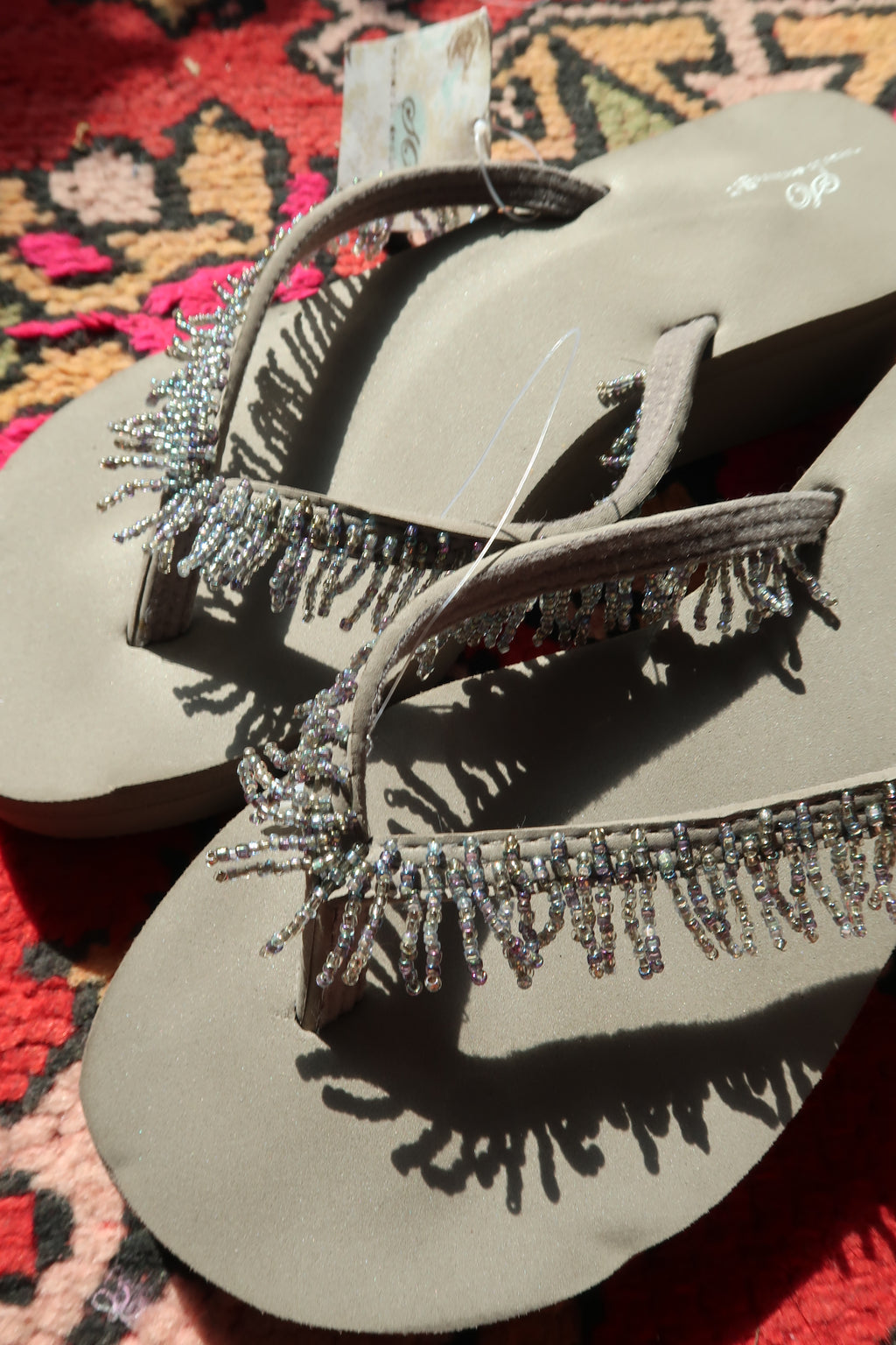 Elektra Vintage taupe grey beaded Y2K vintage flip flops with decorative bead details and flat sole.