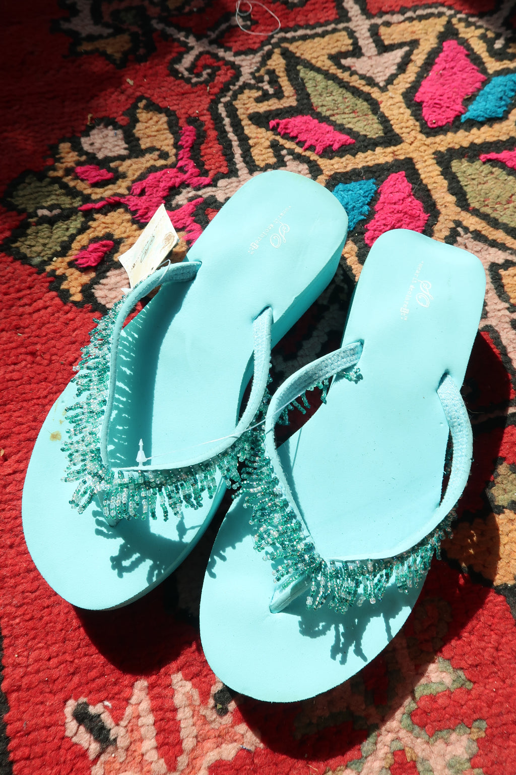 Turquoise Y2K vintage beaded flip flops with new tags by Elektra Vintage, featuring colorful bead detailing on the straps.
