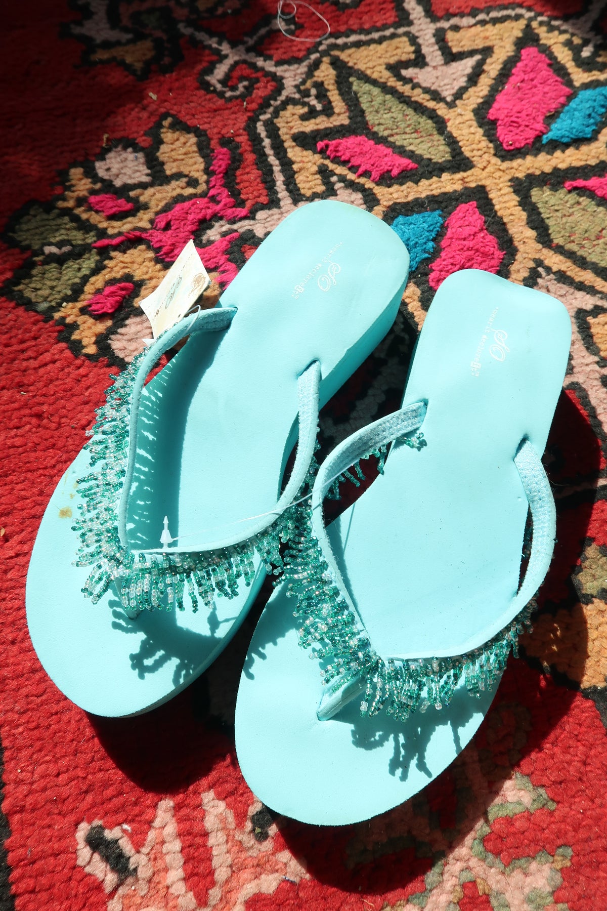Turquoise Y2K vintage beaded flip flops with new tags by Elektra Vintage, featuring colorful bead detailing on the straps.