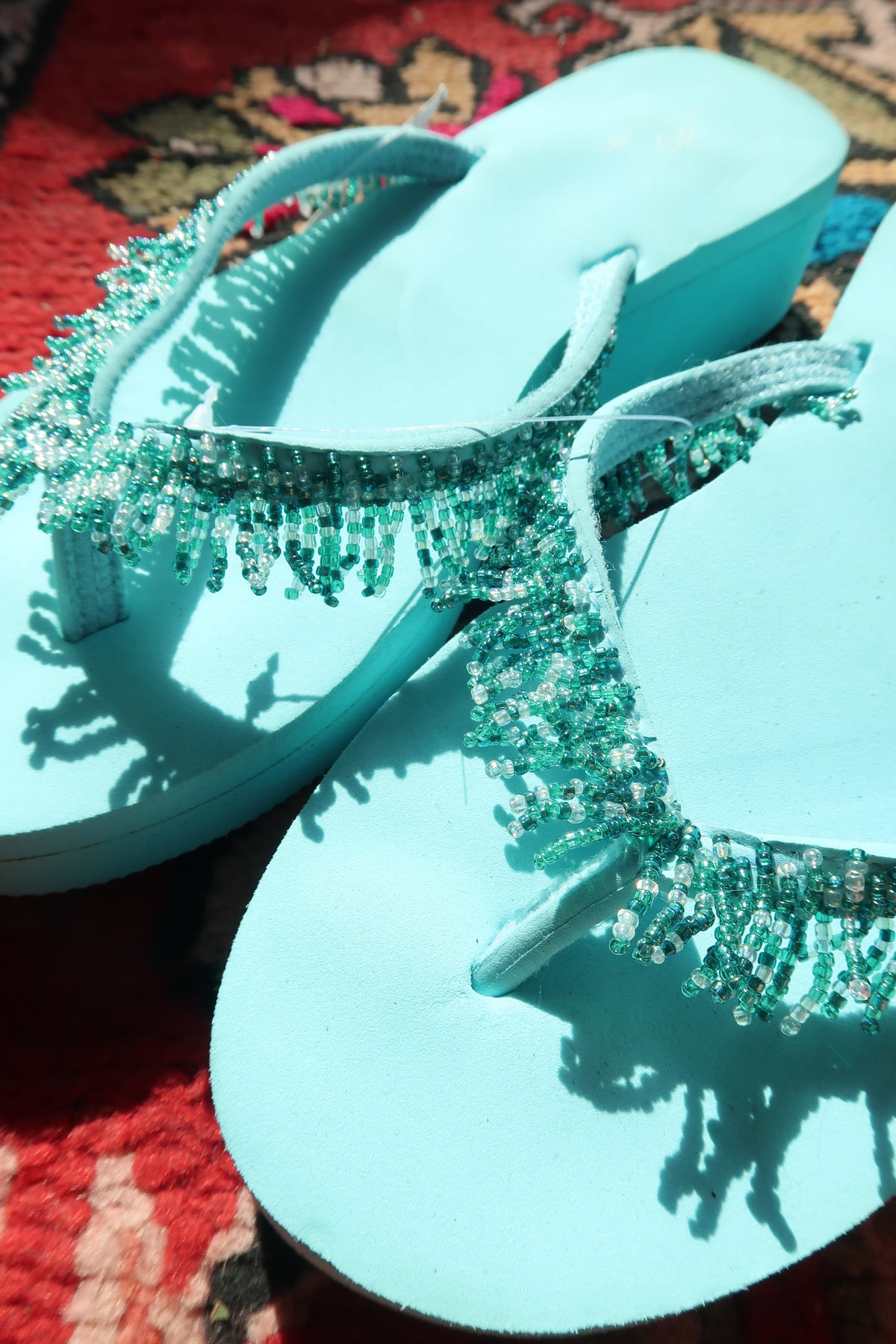Turquoise Y2K vintage beaded flip flops by Elektra Vintage, featuring colorful bead details on comfortable summer footwear.
