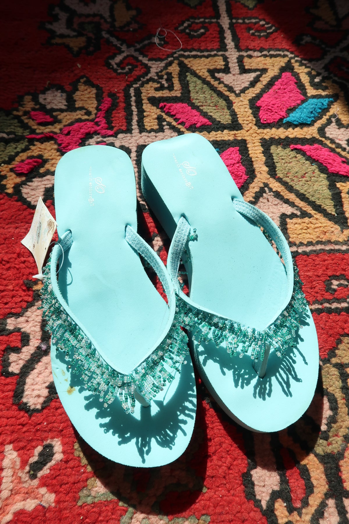 Turquoise Y2K vintage beaded flip flops by Elektra Vintage, featuring colorful bead details and classic slide design.