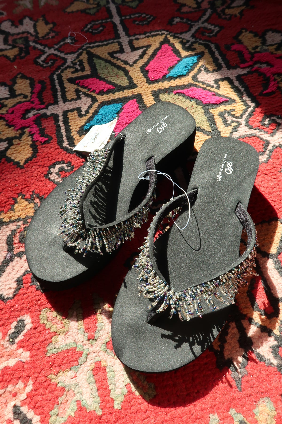 Black Y2K vintage beaded flip flops by Elektra Vintage with colorful bead details and classic slide design.
