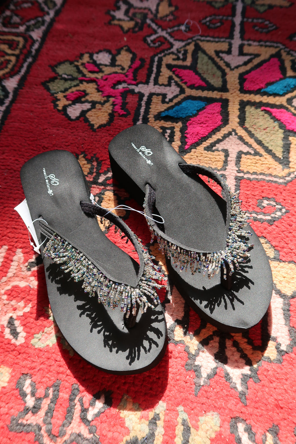 Black Y2K vintage beaded flip flops by Elektra Vintage, featuring colorful bead detailing on the straps.
