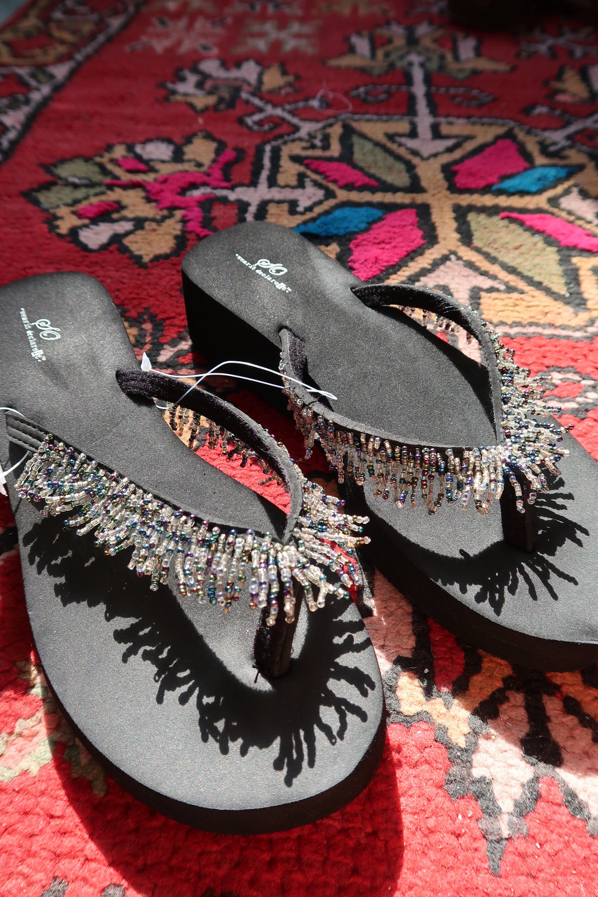 Black Y2K vintage beaded flip flops by Elektra Vintage, featuring colorful beaded straps and a casual summer style.