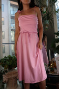 Vintage 1970s pink tie-strap midi dress by Elektra Vintage, soft jersey knit fabric, sleeveless design, and feminine silhouette.