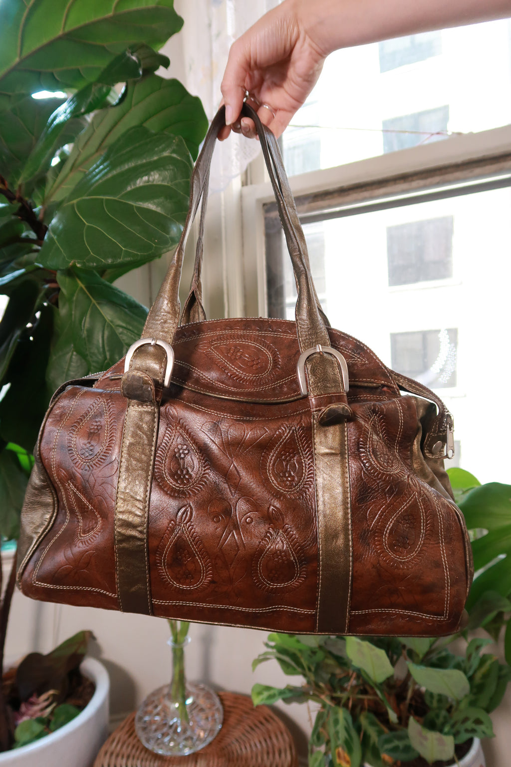 Vintage leather and metallic bronze shoulder bag with embossed western design, stylish Elektra Vintage satchel purse.