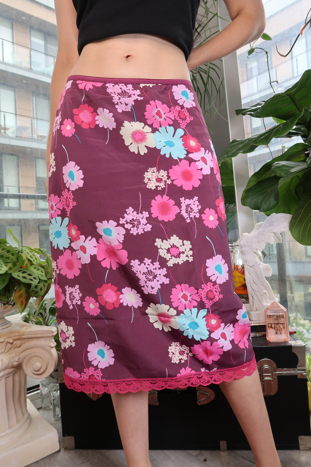 Vintage Y2K floral print slip skirt by Elektra Vintage with lace hem, featuring a lightweight, flowy fabric and retro-inspired design.