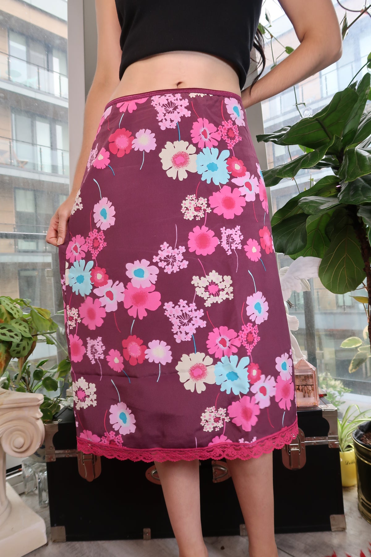 Vintage Y2K floral print slip skirt with lace hem from Elektra Vintage, featuring a flowy fabric and vibrant floral pattern.