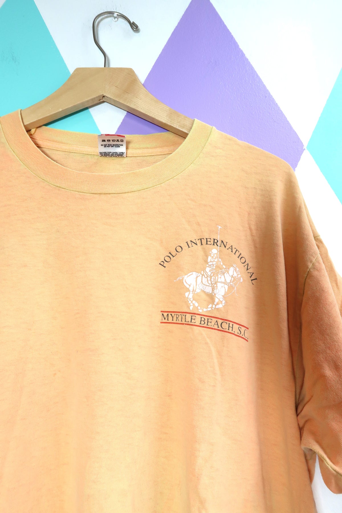 Vintage "Polo International" Myrtle Beach Graphic Tee – Distressed Peach Souvenir Shirt