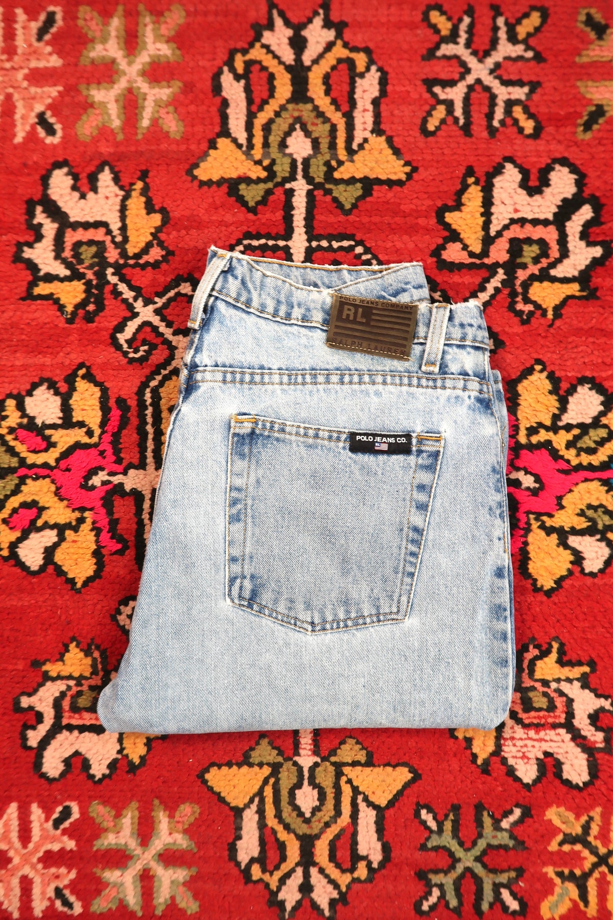 Men's light wash distressed denim jeans by Polo Jeans Co. from Elektra Vintage, featuring a relaxed fit and classic five-pocket design.