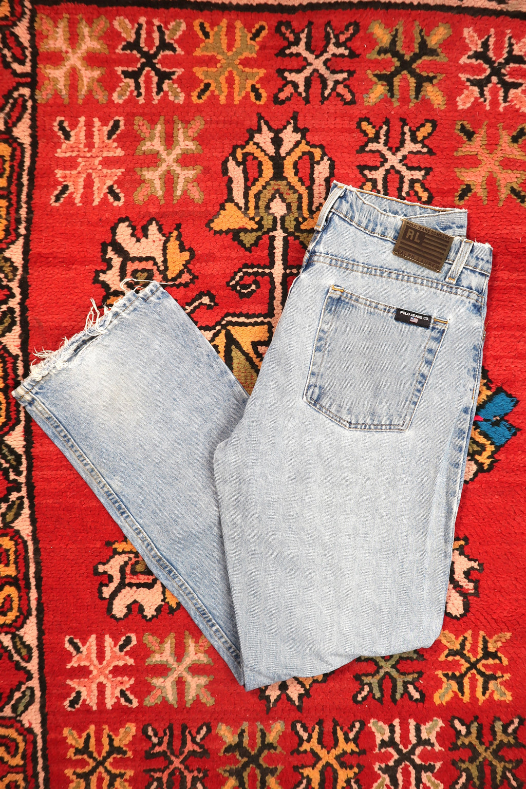 Men's vintage light wash distressed denim jeans by Polo Jeans Co. from Elektra Vintage, showcasing a classic fit and faded details.