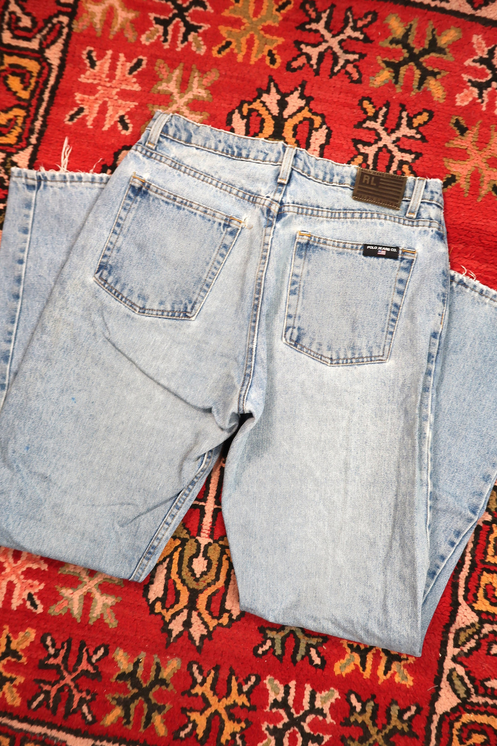 Men's vintage Light Wash distressed denim jeans by Polo Jeans Co. from Elektra Vintage, showing front view with fading and rips.