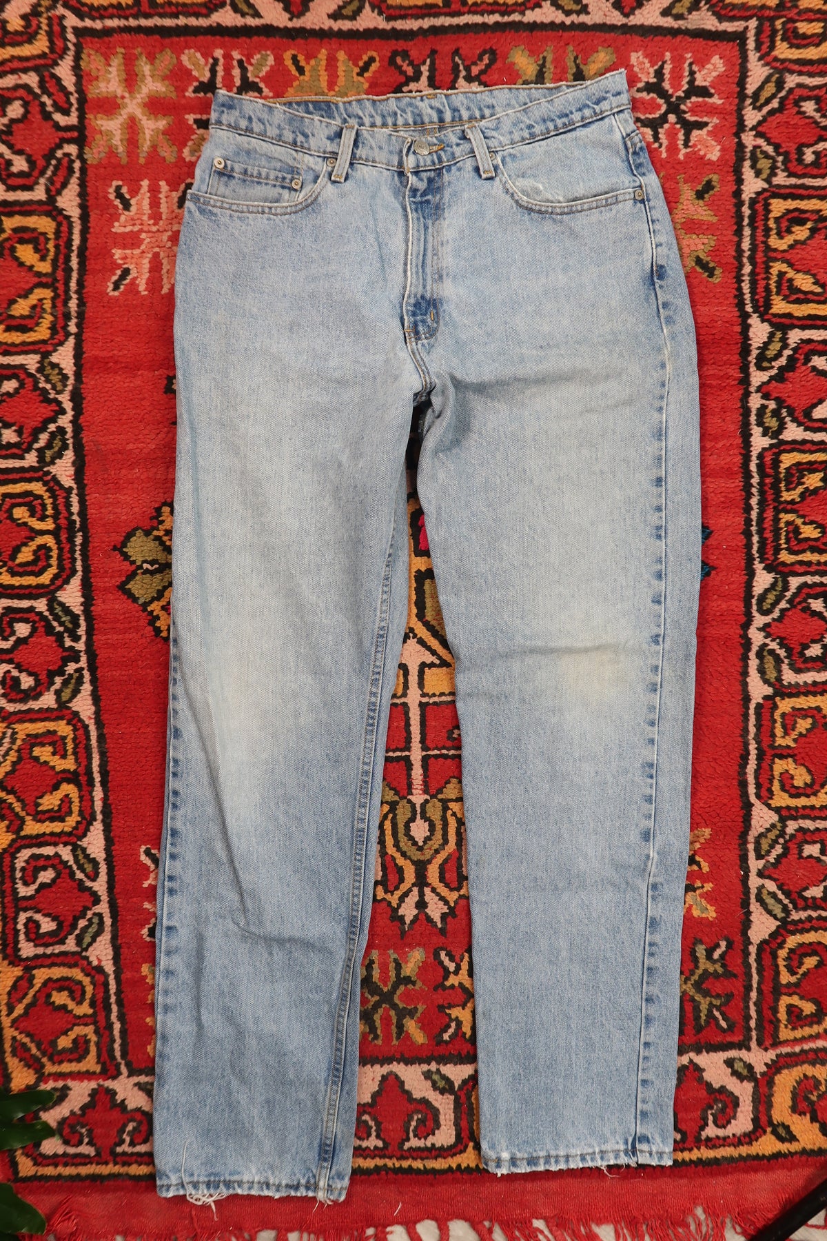 Men's vintage light wash distressed denim jeans by Polo Jeans Co., styled with a relaxed fit and classic five-pocket design.