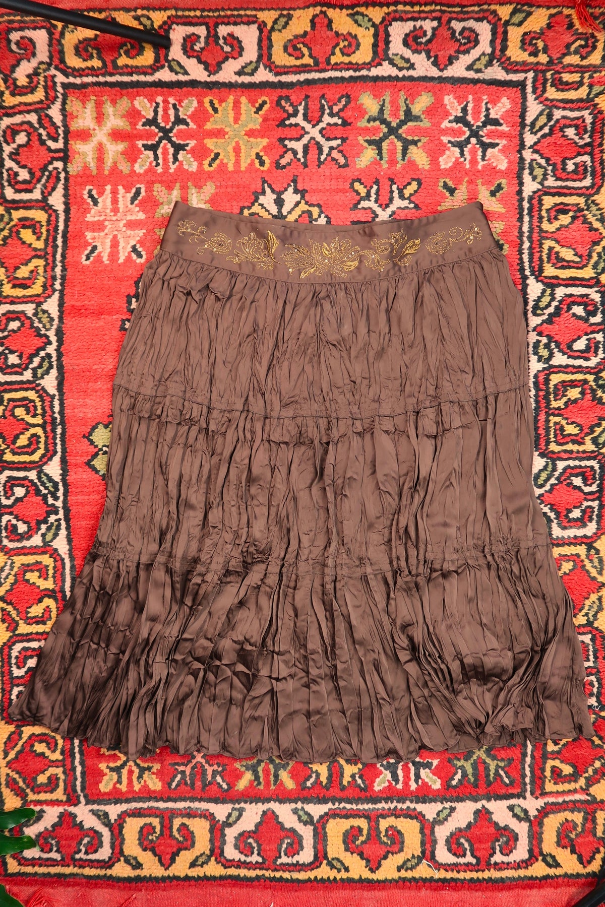 Elegant vintage brown satin crepe midi skirt by Elektra Vintage with gold embroidered waistband and classic 1970s style.