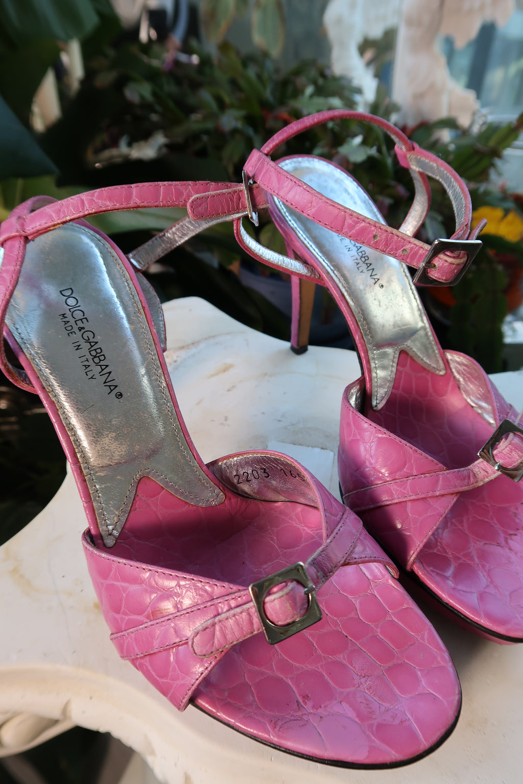 Dolce Gabbana vintage pink alligator leather platform heels with ankle straps and high block heels, styled on a display.