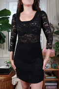 Vintage Diane Von Furstenberg black lace sheath mini dress, elegant and fitted, displayed on a mannequin.
