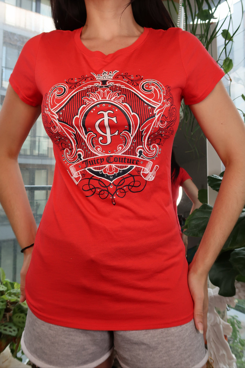 Red Juicy Couture crest logo graphic women's fitted short sleeve tee on Elektra Vintage display.