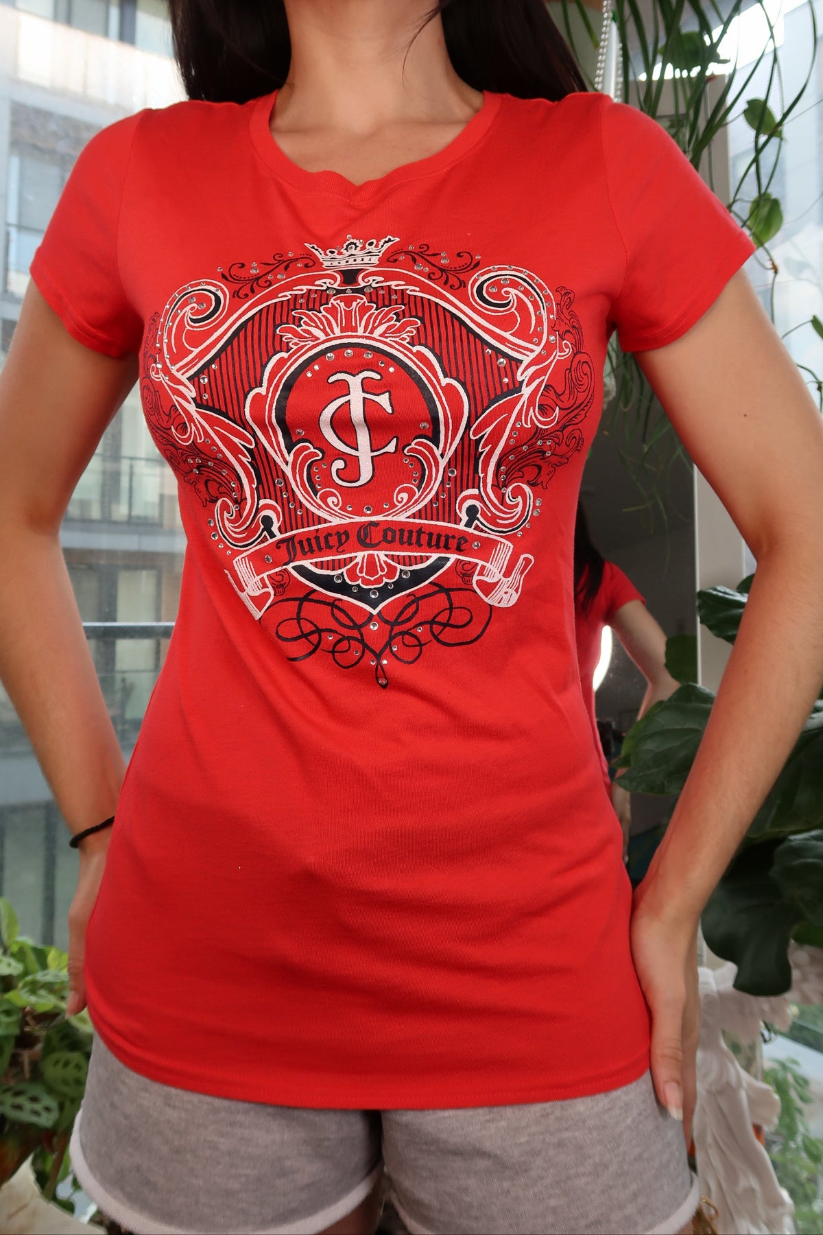 Red Juicy Couture crest logo graphic women's fitted short sleeve tee on Elektra Vintage display.
