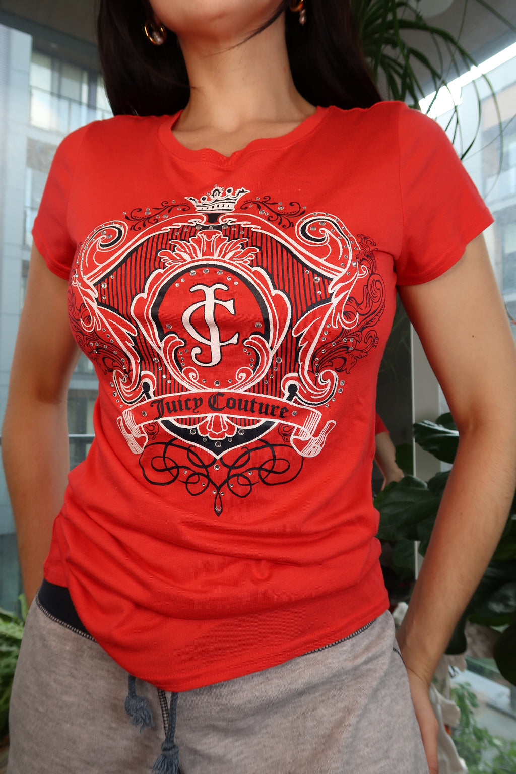 Red Juicy Couture crest logo graphic fitted women's short sleeve tee shirt by Elektra Vintage on a white background.