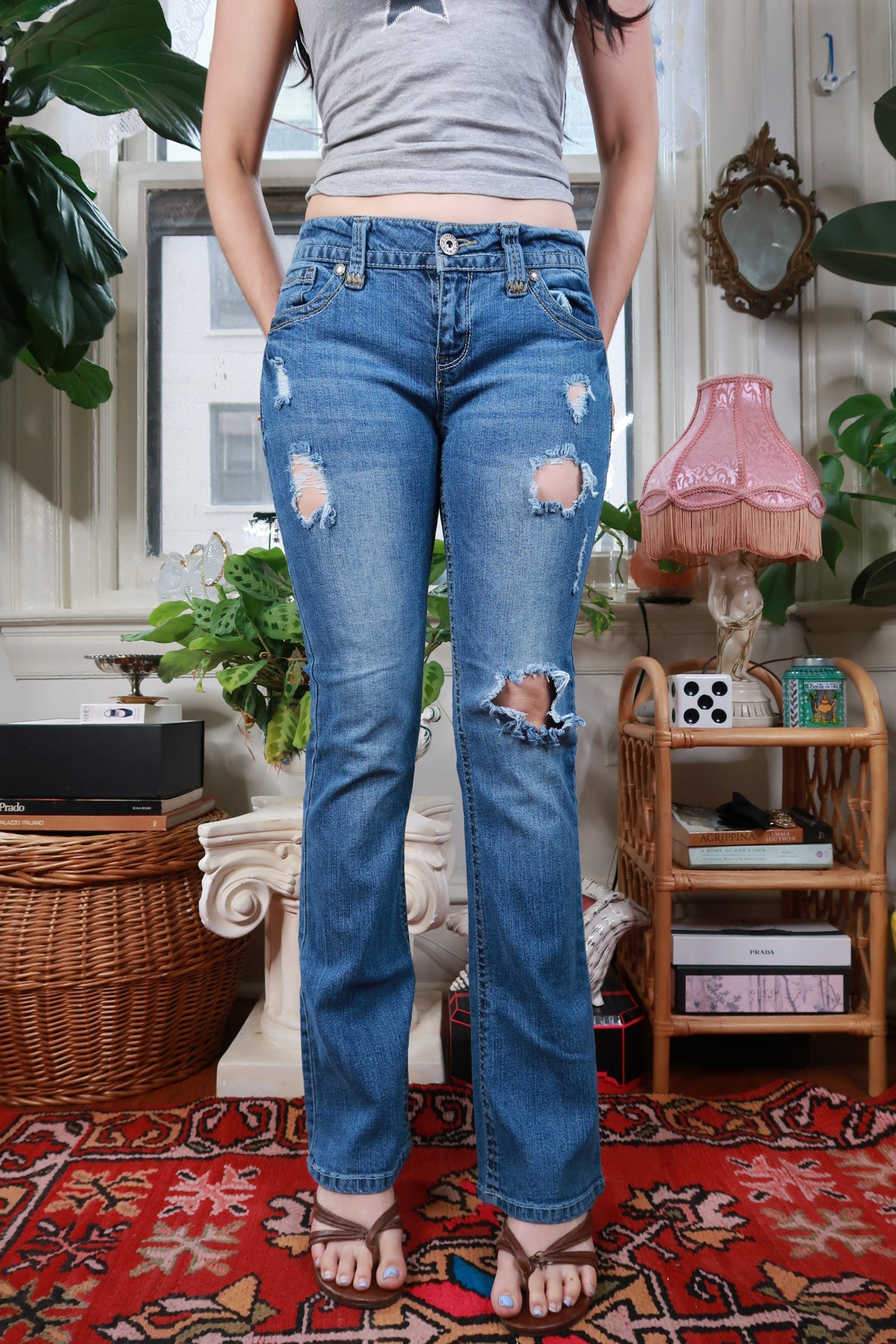 Women's vintage Y2K distressed low rise straight leg jeans by Elektra Vintage, with faded and ripped details.