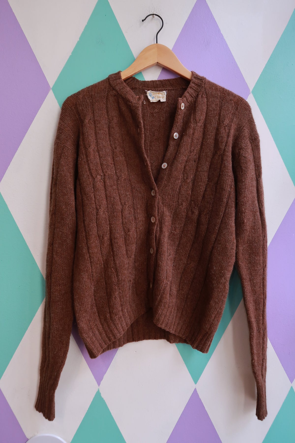 Vintage 1960s John Meyer brown wool button-up cardigan with a classic fit and textured knit, styled on a neutral background.