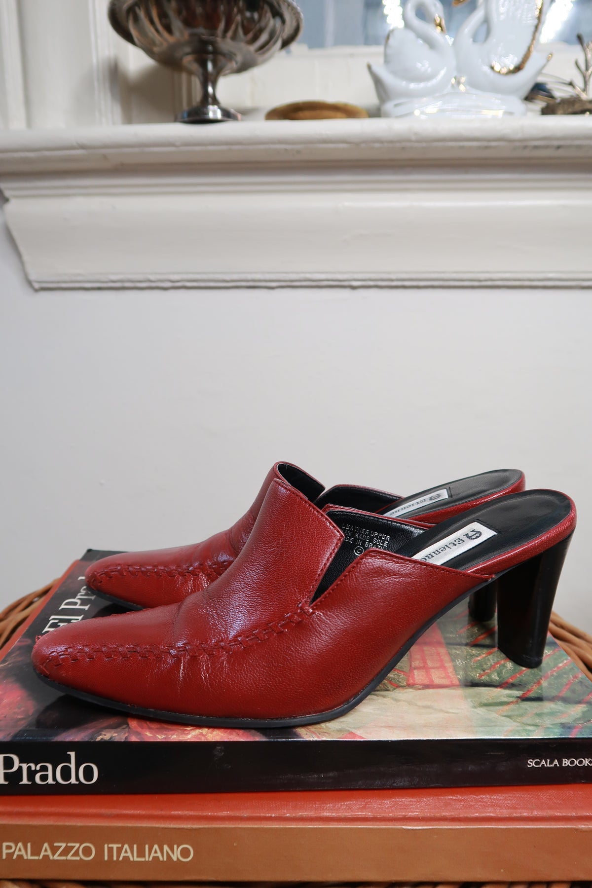 Vintage Etienne Aigner red leather mule heels with pointed toes and block heels, displayed on a neutral background.
