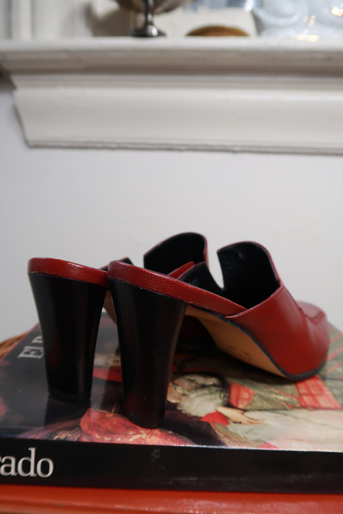 Vintage Etienne Aigner red leather mule heels with pointed toes and low block heels, showcased on a neutral background.