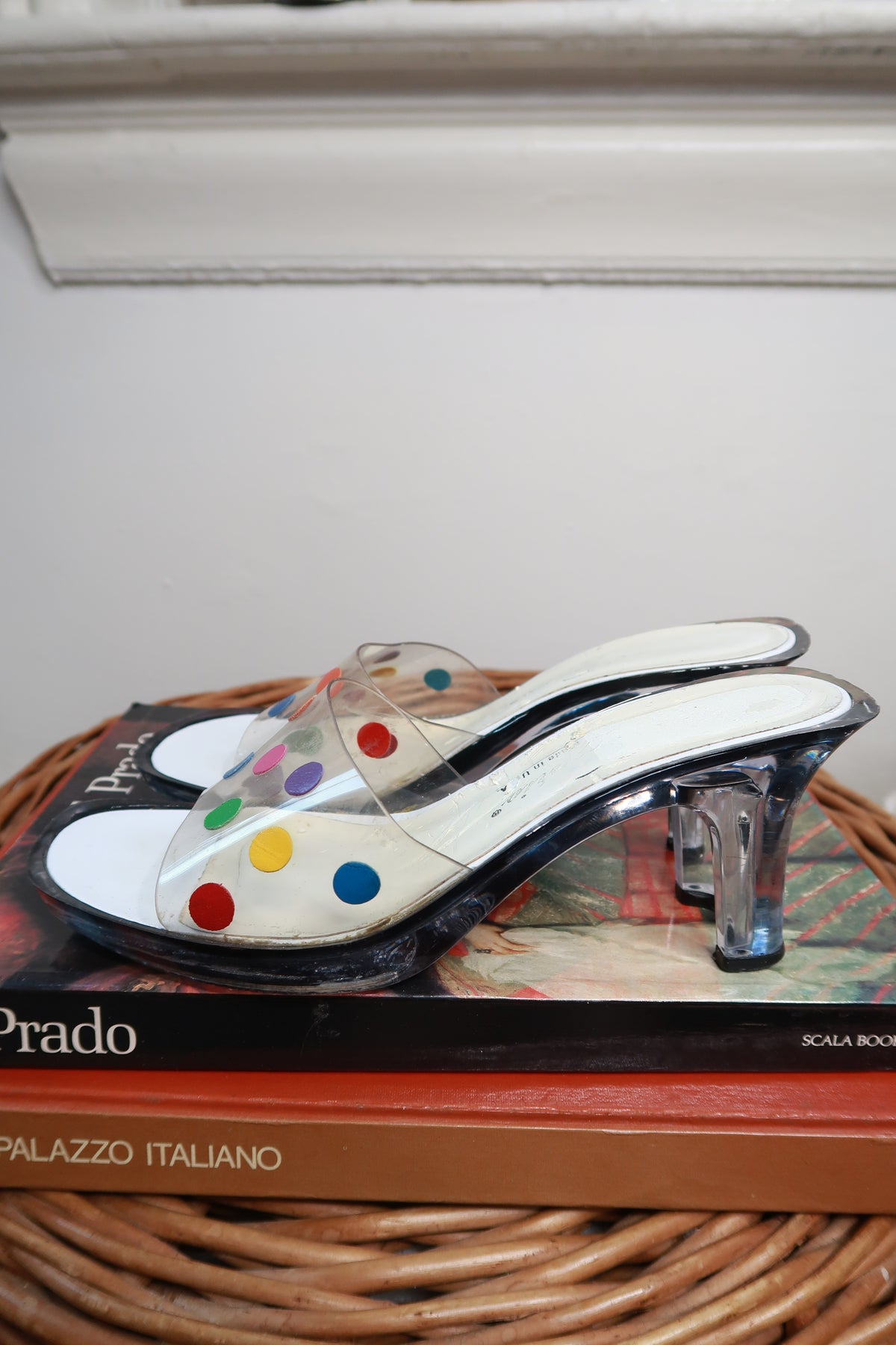 Pair of vintage Y2K clear polka dot Lucite mule heels by Elektra Vintage, showcasing transparent heels and playful polka dot pattern.