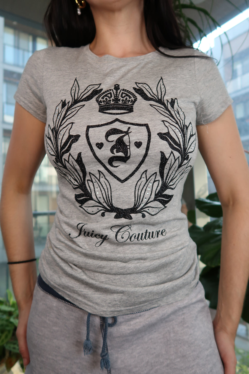 Gray Juicy Couture crest velour graphic tee for women, featuring a stylish logo design, from Elektra Vintage.