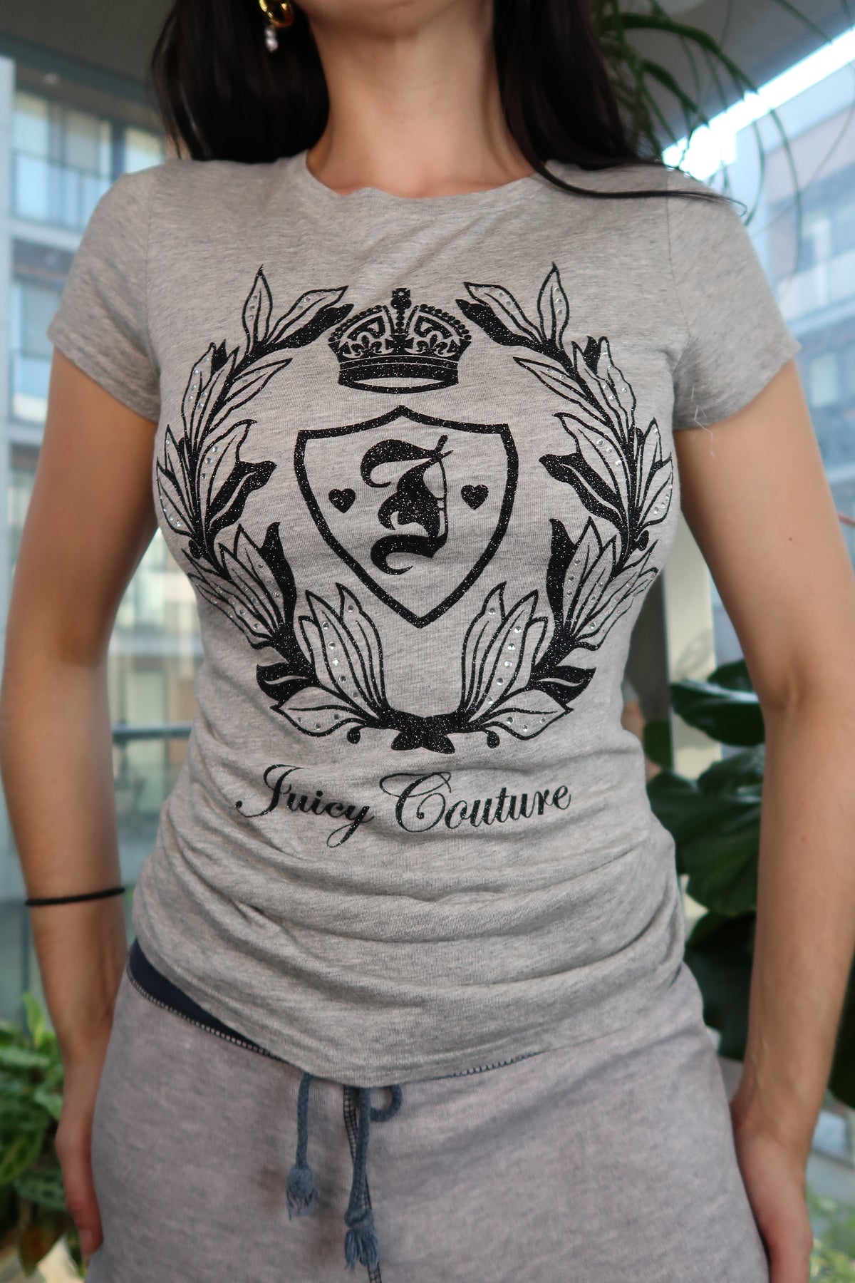 Gray Juicy Couture crest velour graphic tee for women, featuring a stylish logo design, from Elektra Vintage.