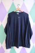 Vintage 2000s Nike navy long sleeve shirt with embroidered swoosh logo, styled casually on a hanger.