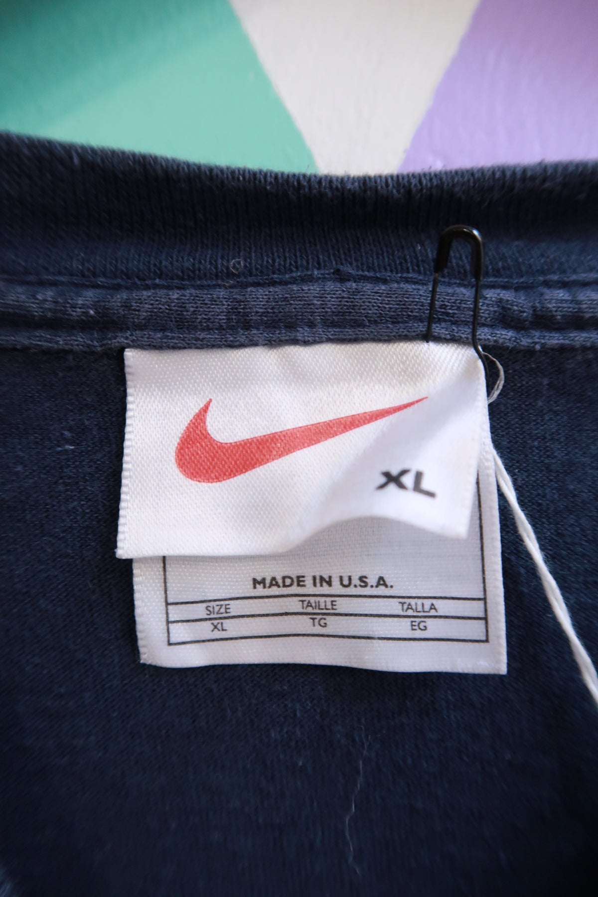 Vintage 2000s Nike navy long sleeve shirt with embroidered Swoosh logo, classic athletic style from Elektra Vintage.