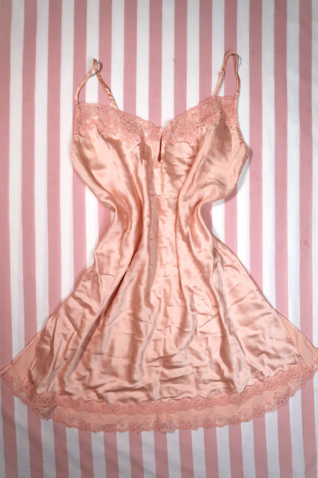 Vintage 2000s Victoria’s Secret peach silk slip dress with lace trim, featuring a delicate and elegant design by Elektra Vintage.