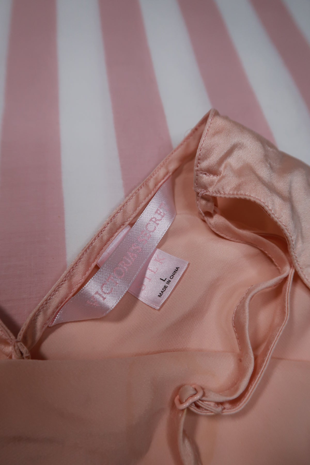 Vintage 2000s Victoria’s Secret peach silk slip dress with lace trim, featuring a silky fabric and delicate lace details.