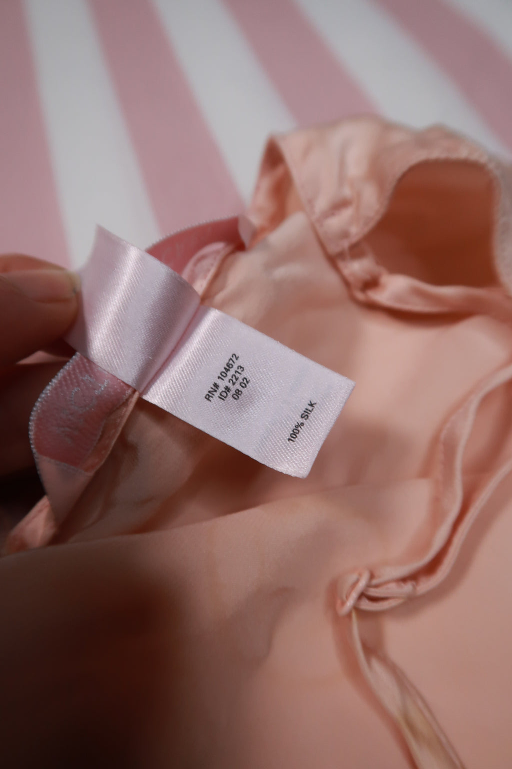 Vintage 2000s Victoria’s Secret peach silk slip dress with lace trim, featuring elegant spaghetti straps and delicate detailing.